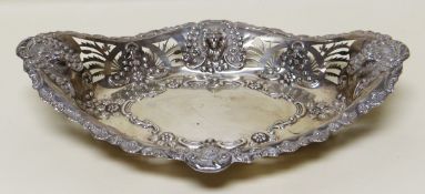 A SILVER BASKET of near oval form and wit open work and repousse decoration including lion heads,