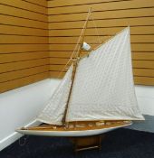 A LARGE POND YACHT with canvas sail and stand, 147cms high