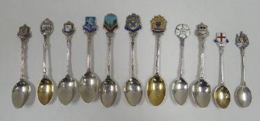 ELEVEN SILVER BRITISH SOUVENIR SPOONS with enamel heraldic terminals, 4.4ozs