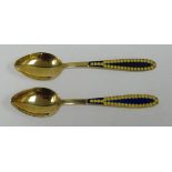 A PAIR OF FINE RUSSIAN SILVER GILT & PLIQUE A JOUR ENAMEL TEA SPOONS, the enamel in blue with yellow