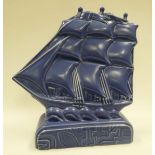A POOLE STUDIO POTTERY SAILING SHIP BY HAROLD STABLER in blue glaze on a geometric patterned base,