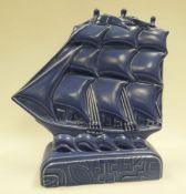 A POOLE STUDIO POTTERY SAILING SHIP BY HAROLD STABLER in blue glaze on a geometric patterned base,