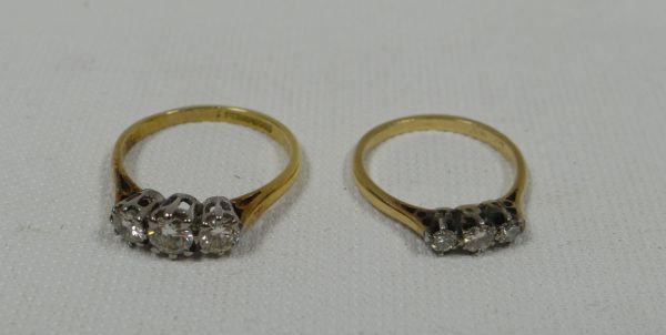TWO DIAMOND THREE STONE ENGAGEMENT RINGS comprising 15ct / platinum ring with centre stone 0.3ct