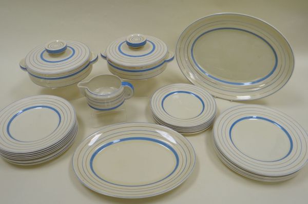 TWENTY-FIVE PIECE CLARICE CLIFF DINNER-SERVICE for Wilkinson with blue banding on a cream ground