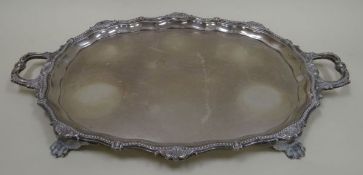 A LARGE SILVER GALLERIED TRAY with twin handles raised on four feet, decorated in the Classical-