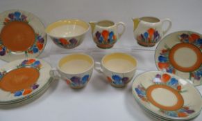 A CLARICE CLIFF 'CROCUS' PART-TEA SET comprising a pair of milk-jugs, sugar basin, two tea-cups,