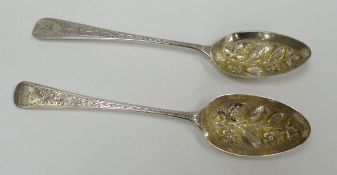 A PAIR OF GEORGE III SMALL SILVER BERRY SPOONS chased with heraldic terminals and floral stems and