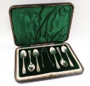 A CASED SILVER TEA-SPOON & SUGAR TONG SET each of the seven pieces floral engraved, Sheffield