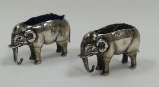 A PAIR OF NOVELTY SILVER PIN-CUSHIONS IN THE FORM OF ELEPHANTS finely detailed with ribbed trunks
