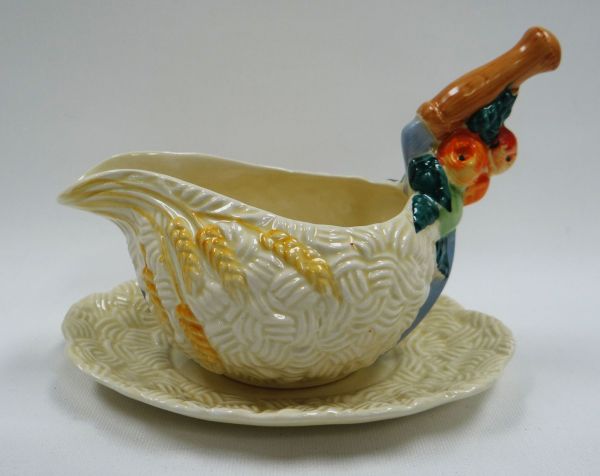 A CLARICE CLIFF 'CELTIC HARVEST' GRAVY-BOAT & STAND, 12cms high