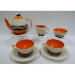 A SUSIE COOPER TEA FOR TWO SET comprising teapot and stand, pair of cups and saucers, cream jug