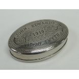 AN OVAL WHITE METAL TOBACCO BOX with hinged lid, the base and lid with sgraffito decoration and