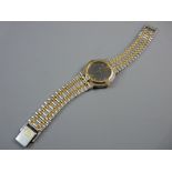 A LADY'S OR GENT'S GUCCI CALENDAR WRISTWATCH, stainless steel and yellow metal decorated having a
