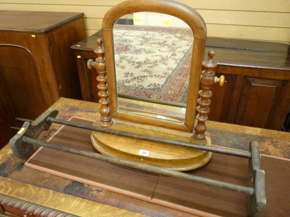 A NEAT OVAL MAHOGANY SWING TOILET MIRROR with shaped supports, shaped stretcher and splayed feet