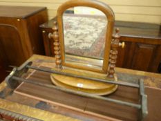 A NEAT OVAL MAHOGANY SWING TOILET MIRROR with shaped supports, shaped stretcher and splayed feet