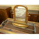 A NEAT OVAL MAHOGANY SWING TOILET MIRROR with shaped supports, shaped stretcher and splayed feet