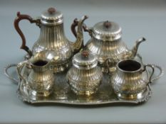 A FIVE PIECE ELECTROPLATED TEA & COFFEE SERVICE, each circular based piece having a band of