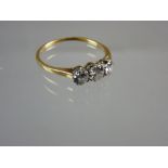 AN UNMARKED GOLD THREE DIAMOND DRESS RING, each round cut diamond of visual estimate 0.15, 0.2 and