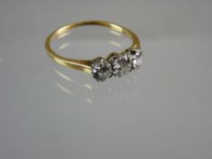 AN UNMARKED GOLD THREE DIAMOND DRESS RING, each round cut diamond of visual estimate 0.15, 0.2 and