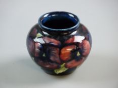 A SMALL BLUE GROUND GLOBULAR MOORCROFT 'PANSY' BOWL, 6.5 cms high, 8 cms diameter