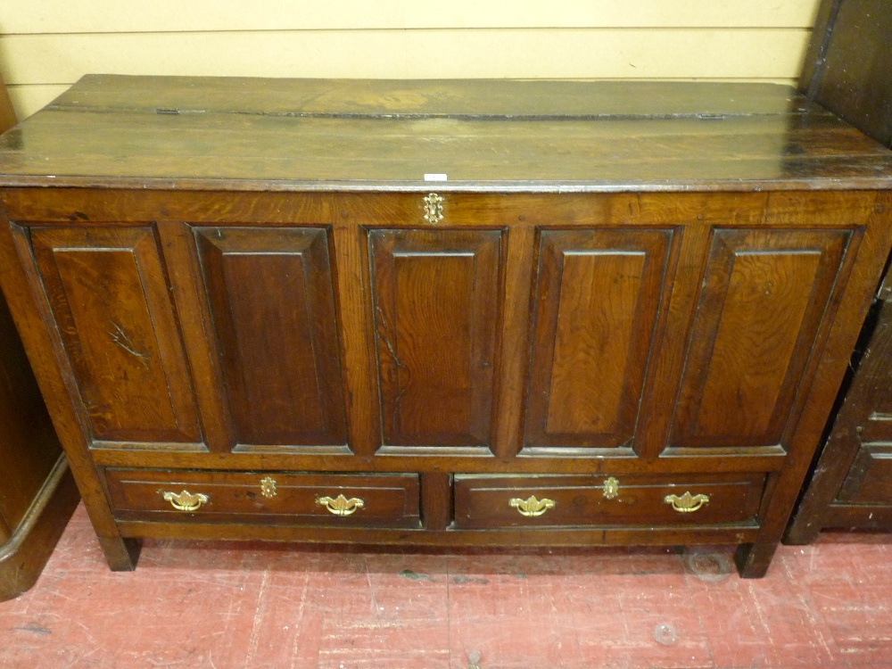 AN 18th CENTURY OAK DOWER CHEST with five fronted fielded panels and a pair of long narrow base