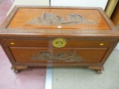 A WELL CARVED ORIENTAL CAMPHOR WOOD CHEST in medium tone teak wood on corner claw feet, 102 cms