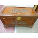 A WELL CARVED ORIENTAL CAMPHOR WOOD CHEST in medium tone teak wood on corner claw feet, 102 cms