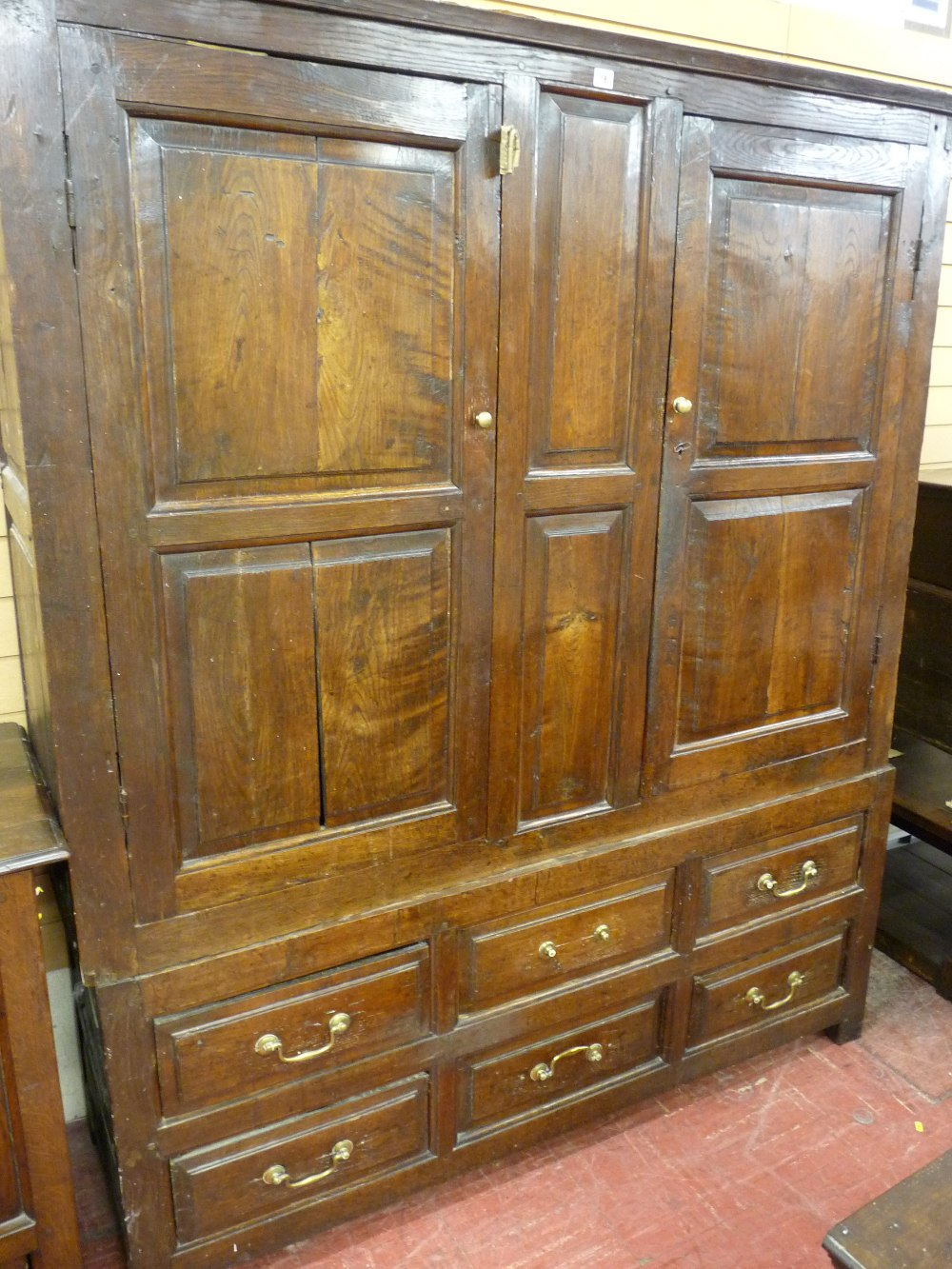AN 18th CENTURY TWO PIECE WELSH OAK PRESS of wide form, the upper section having two doors, each