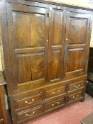 AN 18th CENTURY TWO PIECE WELSH OAK PRESS of wide form, the upper section having two doors, each