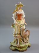 A CONTINENTAL SCHOOL PARIAN FIGURINE of a standing country girl with a young deer at foot on a