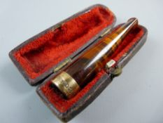 A CASED AMBER CIGARETTE HOLDER with nine carat gold band, Chester 1898