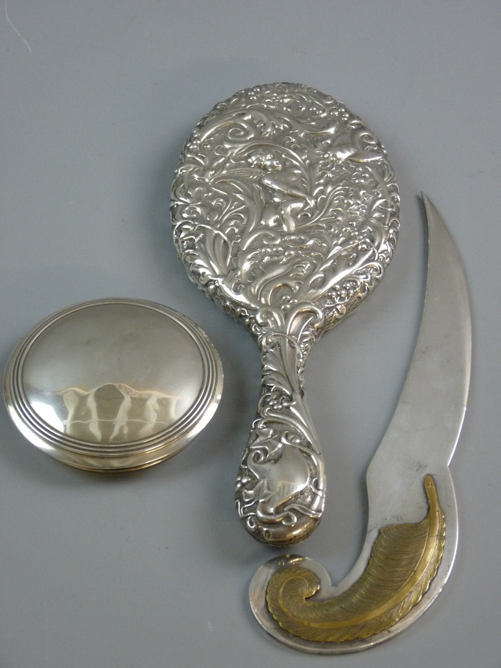 A SILVER BACKED OVAL DRESSING MIRROR with bevelled glass, Birmingham 1897, a circular silver lid