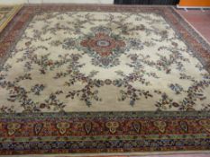 A FLORAL WOOL MIXTURE CARPET having a six row outer floral band with a fawn centre with large