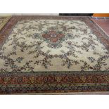 A FLORAL WOOL MIXTURE CARPET having a six row outer floral band with a fawn centre with large