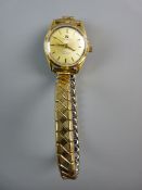 A TISSOT LADY'S AUTOMATIC C-STAR WRISTWATCH, entirely gold coloured with expanding strap