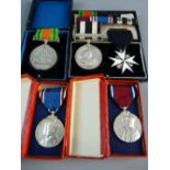 A GROUP OF FIVE PRE 1950s AWARDS AND MEDALS to include a GV & Queen Mary Jubilee in original box,