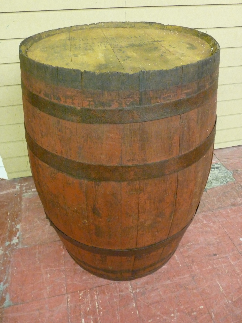 A COMPLETE METAL BANDED OIL BARREL, 86 cms high, diameter at top 55 cms