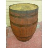 A COMPLETE METAL BANDED OIL BARREL, 86 cms high, diameter at top 55 cms