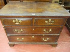 AN EARLY 19th CENTURY OAK CHEST OF DRAWERS having two long and two short drawers with brass swan