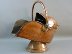 A CIRCULAR BASED COPPER HELMET COAL SCUTTLE with swing handle and brass end handle