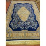 A LARGE BLUE AND FAWN GROUND WELL PRESERVED WASHED CHINESE RUG, approximately 2.7 x 1.8 metres