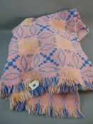 A LARGE PINK PATTERNED WELSH WOOLLEN BLANKET