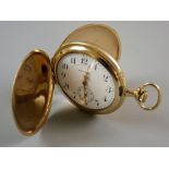 A WALTHAM FULL HUNTER POCKET WATCH, the gold coloured case fully chase decorated, the white interior