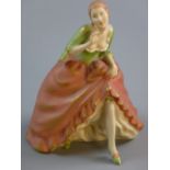 A ROYAL DUX SEMI-GLAZED TRADITIONAL FIGURINE of a lady in a flowing pink dress and green blouse,