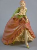 A ROYAL DUX SEMI-GLAZED TRADITIONAL FIGURINE of a lady in a flowing pink dress and green blouse,