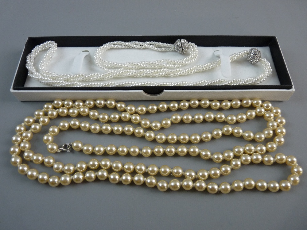 A TRIPLE STRAND ARTIFICIAL PEARL NECKLACE with orb clasp decorated zircons with matching bracelet