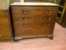 A GEORGIAN MAHOGANY CHEST OF FOUR LONG DRAWERS with top brushing slide with brass swan neck