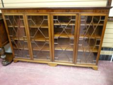 A GOOD EARLY 20th CENTURY MAHOGANY FOUR DOOR BOOKCASE having an inverted moulded top over a