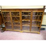 A GOOD EARLY 20th CENTURY MAHOGANY FOUR DOOR BOOKCASE having an inverted moulded top over a