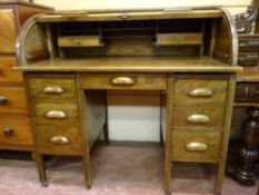 A GOOD TWIN PEDESTAL ROLL TOP DESK having a tambour cylinder desk top with fitted interior of